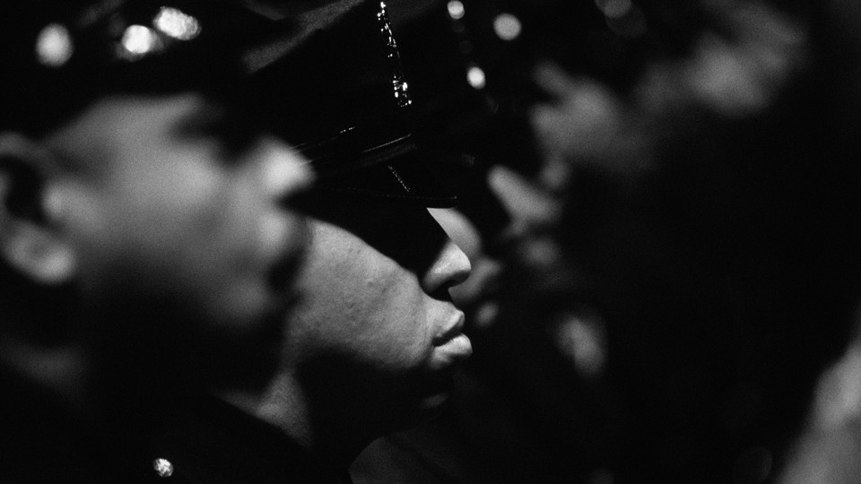 A black-and-white photo of a rank of police officers.