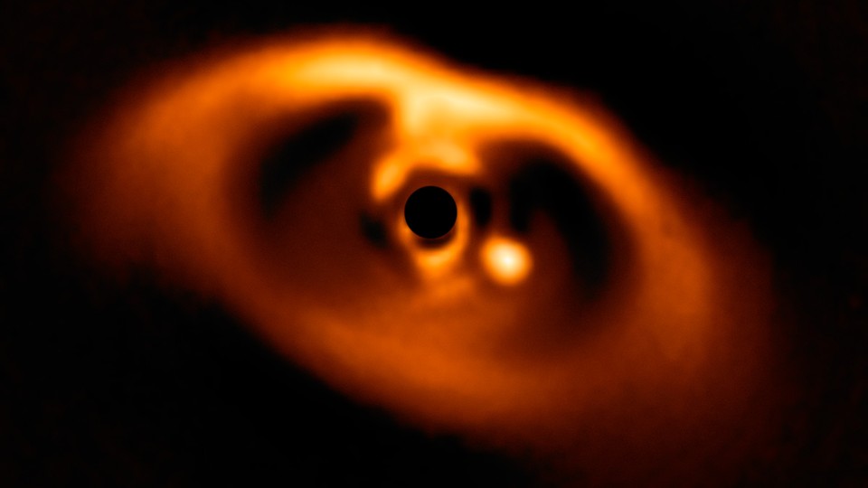 A baby planet orbiting a star, as seen through ESO’s Very Large Telescope