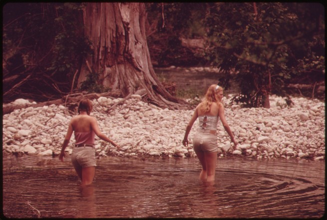 Two friends wade in the Frio Canyon River near San Antonio, Texas, in 1970