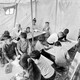 a black and white photograph of kids studying in a tent in Gaza.