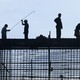 Silhouetted construction workers