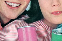 Vintage photograph of two young people smiling and holding colorful cans