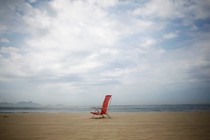 A folding chair on a beach