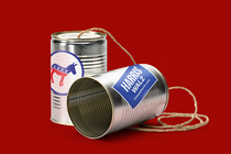 Illustration of two metal cans hooked up to speak to each other, bearing Democratic Party insignia