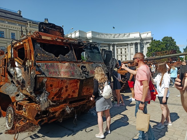 Natalya scrawls graffiti with lipstick on a Russian mobile missile launcher in Kyiv