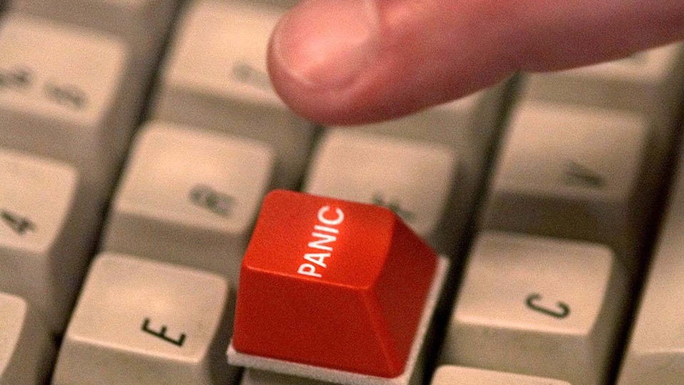 red panic button on a white keyboard