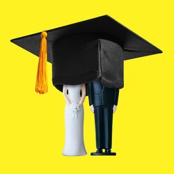 A wedding-cake topper covered with a graduation cap