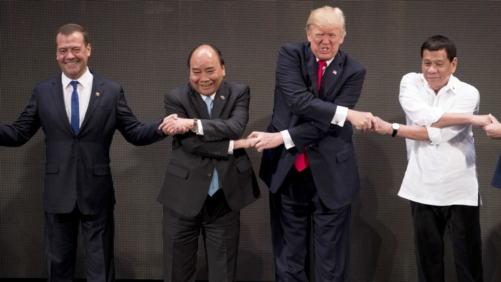 President Trump takes part in the "family photo" at the ASEAN summit.