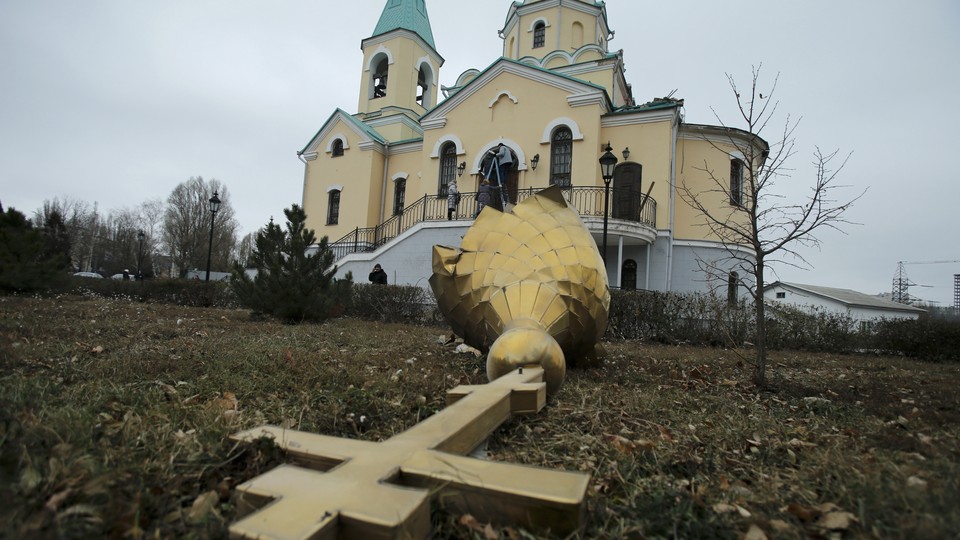 A damaged dome in the yard of an Orthodox church damaged by shelling in Donetsk, eastern Ukraine, in 2014