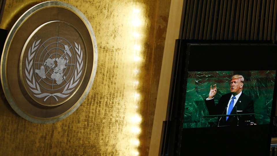 President Trump appears on a screen opposite the United Nations logo