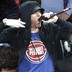 Eminem yells to the crowd before the start of an NBA basketball game between the Detroit Pistons and the Charlotte Hornets, Wednesday, Oct. 18,2017, in Detroit.