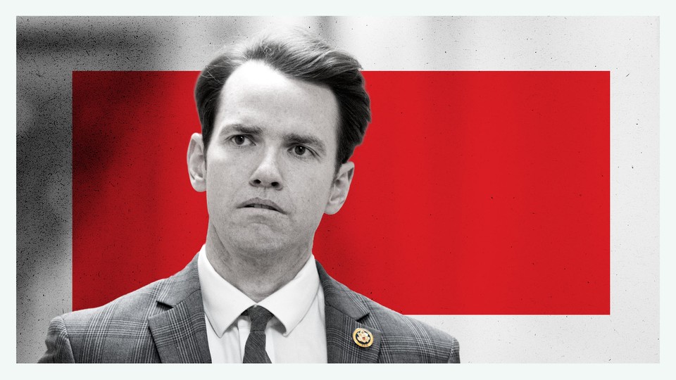 A black-and-white photograph of Kevin Kiley in front of a red square