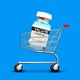 An enlarged COVID-19 vaccine vial in a shopping cart