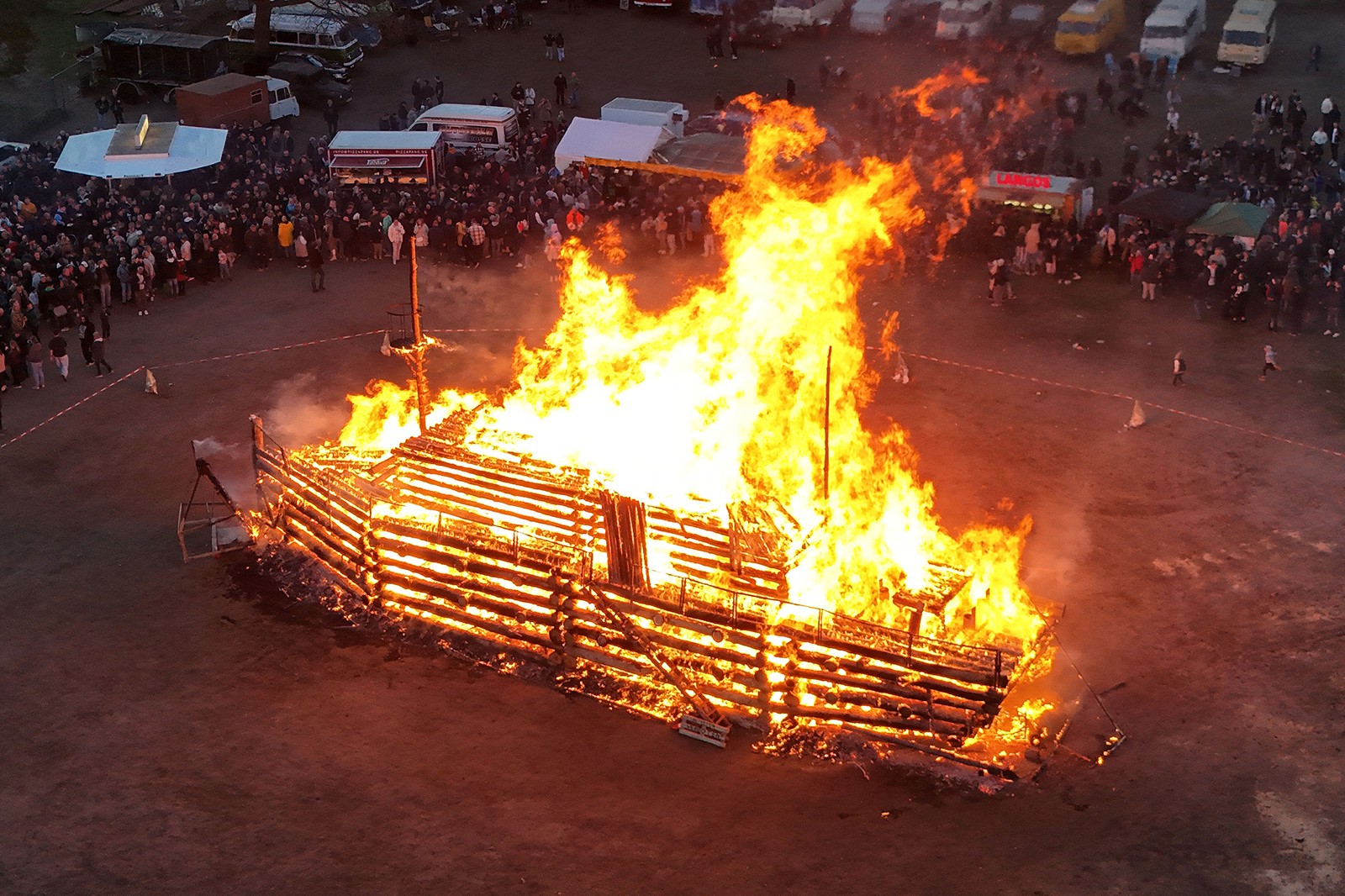 A model of the Titanic made out of logs burns up in a bonfire.