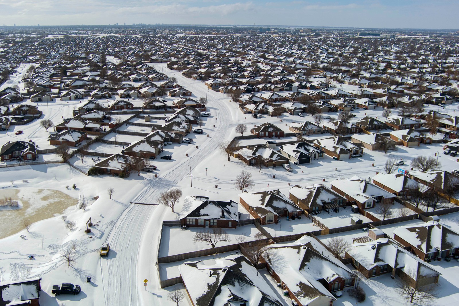 An aerial view of a residential neighborhood covered in a fresh snowfall.