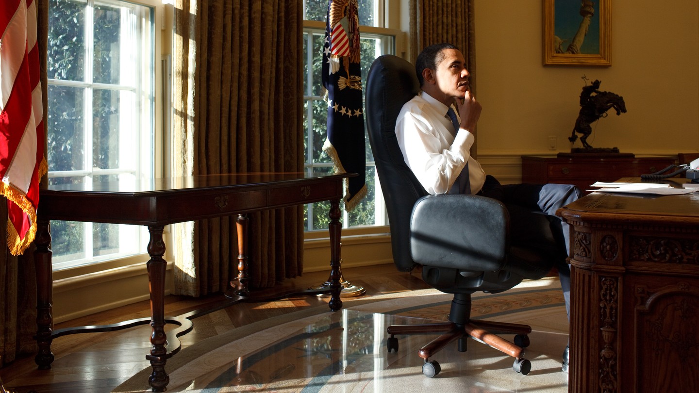 President Obama sits at the Resolute Desk in the Oval Office