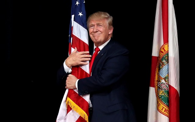Donald Trump hugging an American flag