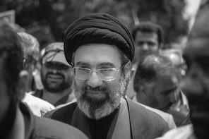 Black and white photograph of Mojtaba Khamenei in a crowd of people.