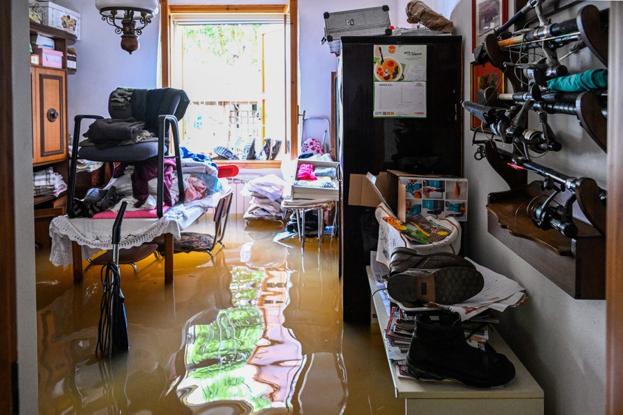 Flood water about two feet deep fills a room inside a house.