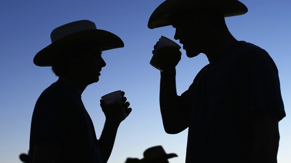 The silhouettes of two people drinking.
