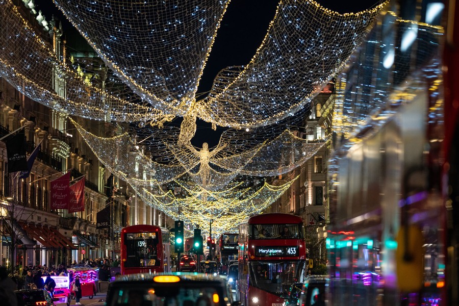 Christmas lights that resemble giant angels hang above a street in London.