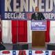 Robert F. Kennedy Jr. speaking at a lectern in front of a banner that says "Declare your independence"