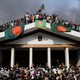 Anti-government protestors display Bangladesh’s national flag as they storm the prime minister’s palace.