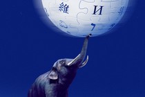 An elephant balances the Wikipedia logo with its trunk.