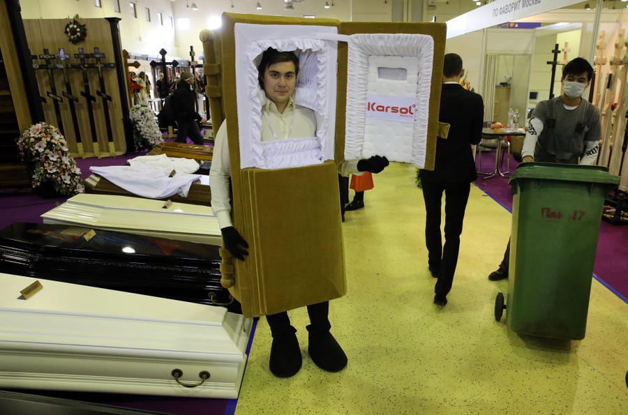 A person dresses in a coffin costume during a funeral fair.
