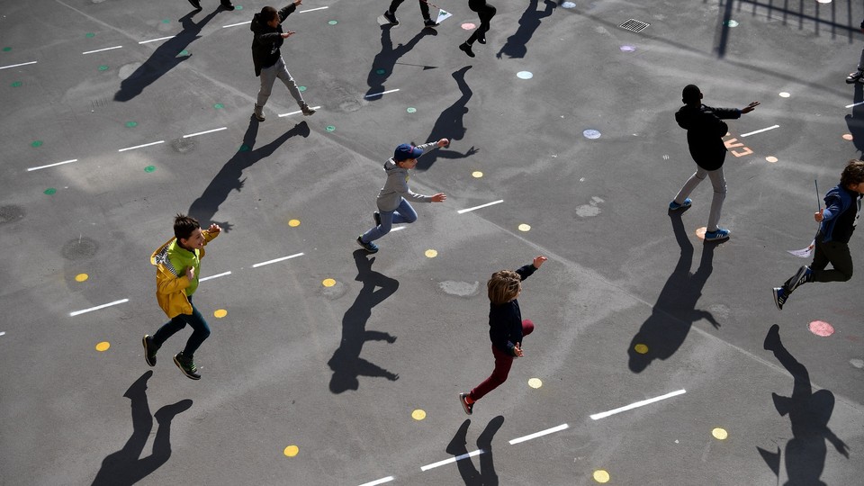 Students playing outside of reopened schools in Paris on May 14