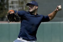 Tim Tebow throws a ball. 