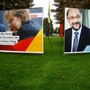 Election campaign posters show Angela Merkel and Martin Schulz side by side on the grass.