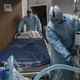 Doctors in Texas wheel a bed in a hospital