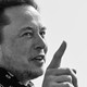 A black-and-white photo of Elon Musk with a bandana around his neck