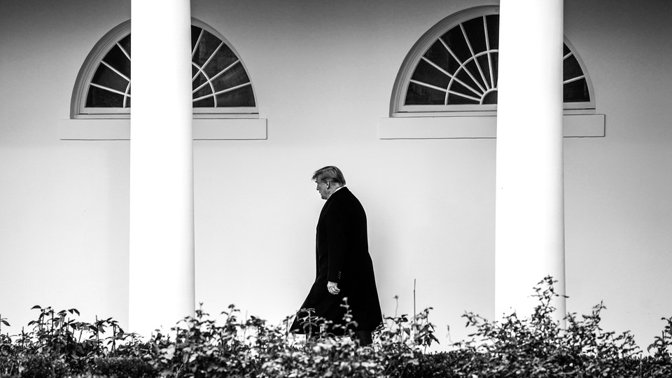 President Trump walks in front of the White House.