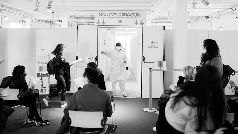 A nurse calls on patients waiting for the AstraZeneca COVID-19 vaccine at the Museum of Science and Technology in Milan, March 22.