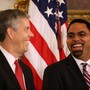 Arne Duncan and John King smile at one another