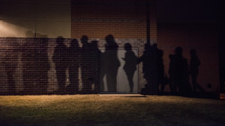 The shadows of voters lined up outside a 2016 caucus location in West Des Moines, Iowa.