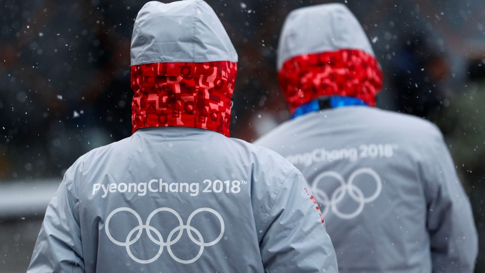 Volunteers for the upcoming 2018 Pyeongchang Winter Olympic Games walk in Pyeongchang.