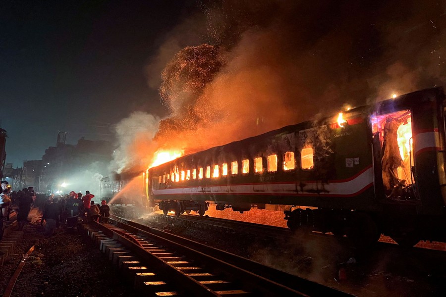 Firefighters try to extinguish a fire on a passenger train.