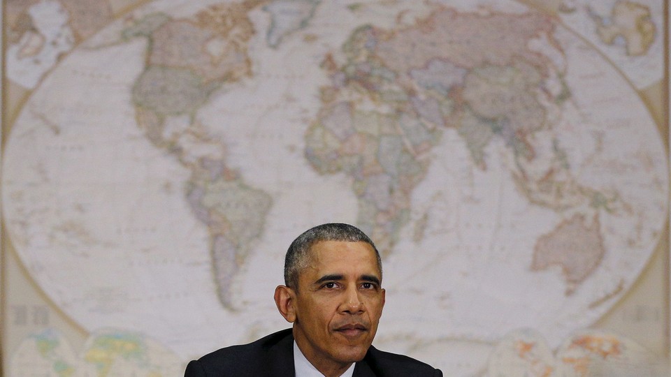 Sitting in front of a world map, U.S. President Barack Obama attends a meeting with the National Security Council at the State Department in Washington February 25, 2016.