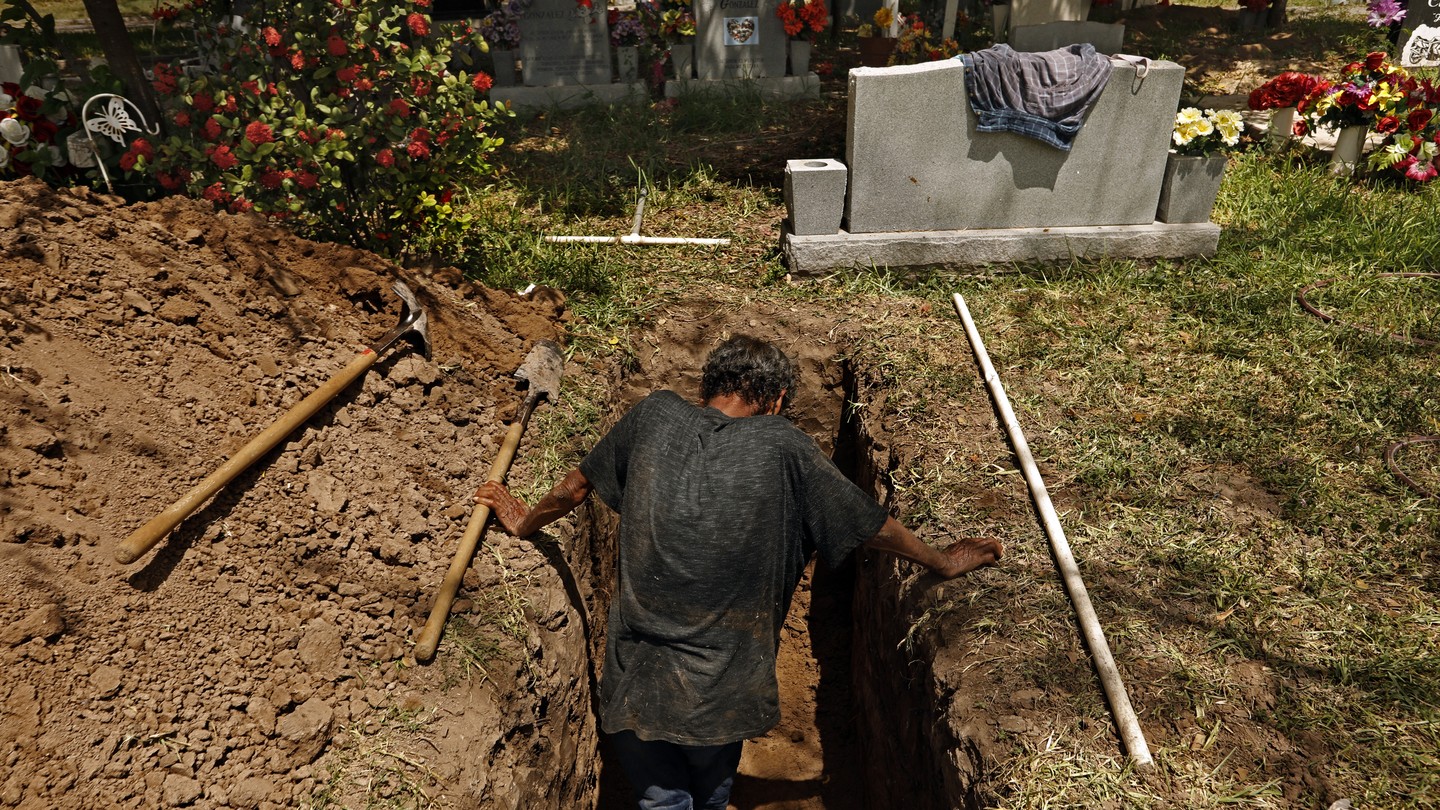 Jesus Torres digs graves at La Piedad Cemetery in McAllen, Texas.