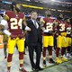 The Washington football team owner Daniel Snyder stands with the players Josh Norman, Bashaud Breeland, and D.J. Swearinger during the playing of the national anthem before a game.