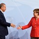 German Chancellor Angela Merkel greets Turkey's President Recep Tayyip Erdogan shake hands on stage at the G20.