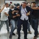 An image of Brad Lander being pulled down the hallway of a federal courthouse