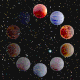 An animation of a ring of colorful planets, blinking in the style of a circular loading icon, set against the star-speckled darkness of space