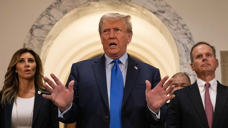 Former U.S. President Donald Trump, center, speaks to members of the media at the New York State Supreme Court on Monday, October 2, 2023.