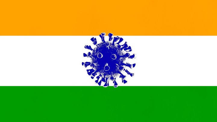 The Indian flag with an image of the coronavirus in the middle.