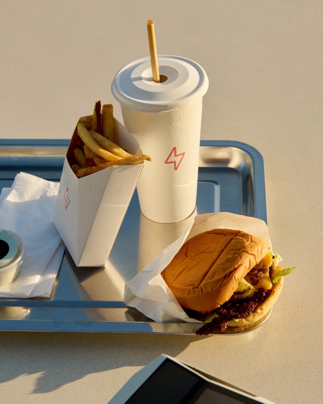 A color photograph of Tesla Diner, with people taking photographs from the balcony