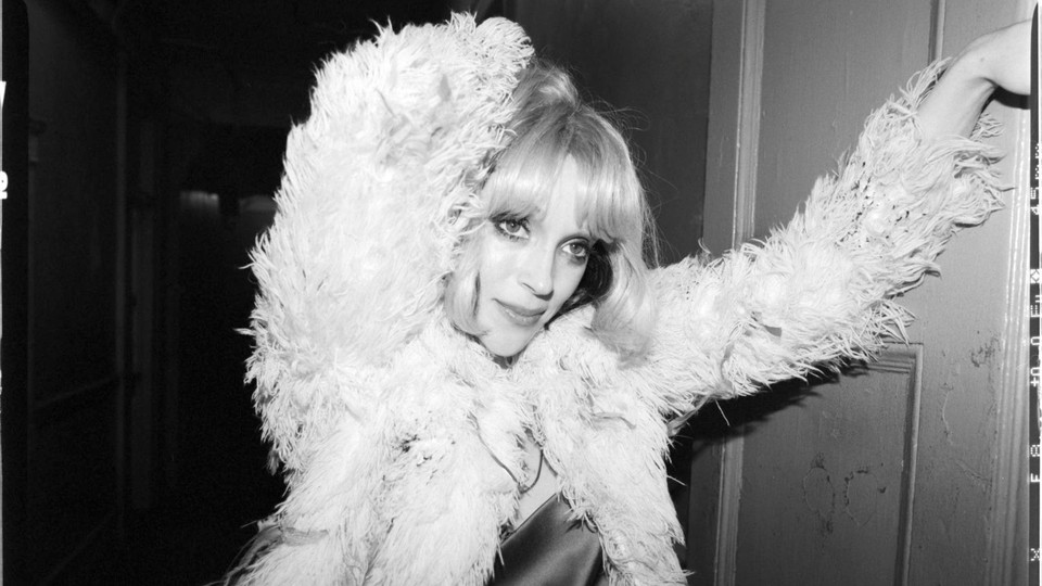 A black-and-white picture of a blonde St. Vincent in a fluffy jacket